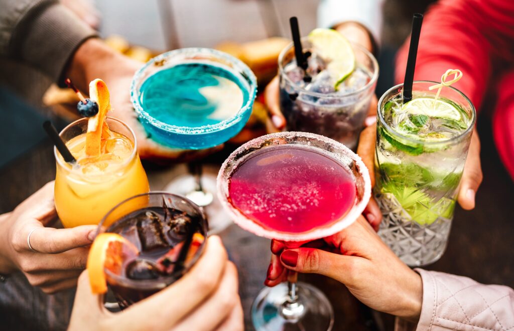 People holding colorful mocktails