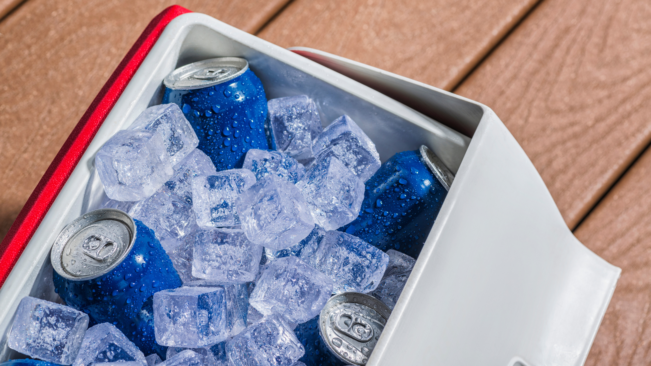Cold drinks stored in a cooler with ice, showing proper storage for seltzers at parties or outdoor events.